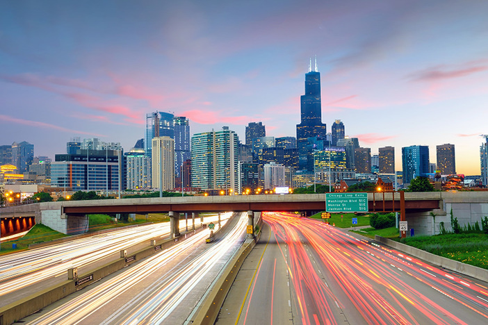 What to Do If You’re Located in an Expensive Real Estate Market Chicago downtown skyline at twilight with highway and traffic.