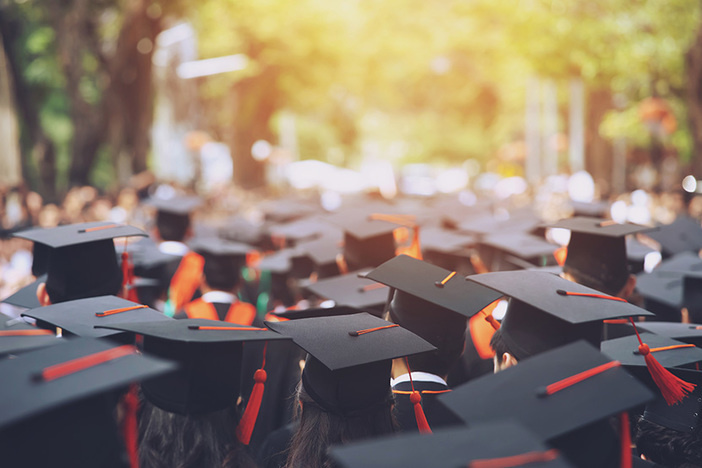 How to Know Which College Savings Accounts Are Right for Your Family (& the Unique Way Investors Can Maximize Savings!) backside graduation hats during commencement ceremony