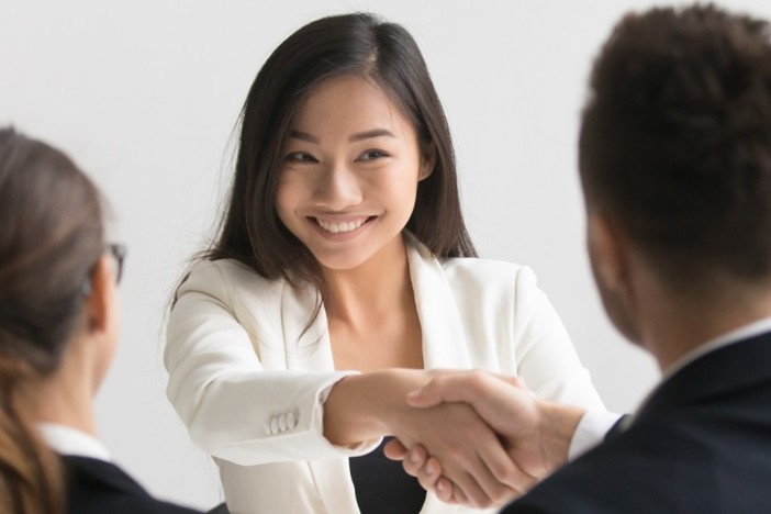 14 Expert Tips to Get Loans Approved (Conventional OR Private Money!) three young business people sitting at desk two are shaking hands