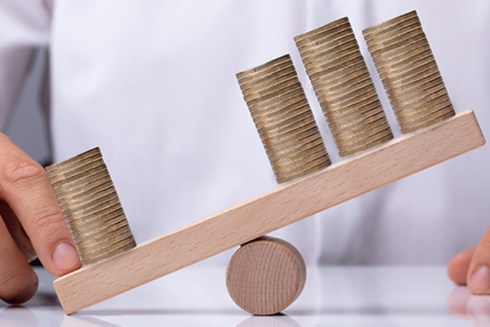 A Whole New Way to Look at Leverage businessperson showing unbalance between stacked coins