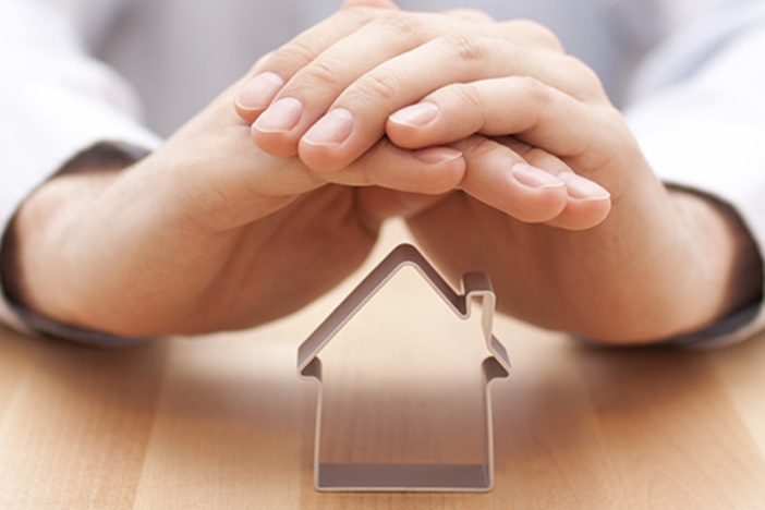 The Most Important Real Estate Investing Decision (Aside from Selecting Properties) closeup of hands clasped shielding cookie cutter in shape of house