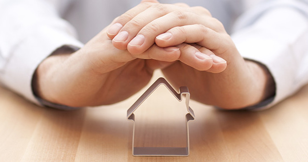 The Most Important Real Estate Investing Decision (Aside from Selecting Properties) closeup of hands clasped shielding cookie cutter in shape of house