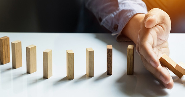 What to Do When a Deal Goes Sideways (Hint: Don’t Panic!) businessman hand stop dominoes continuous toppled, Panoramic composition suitable for banners