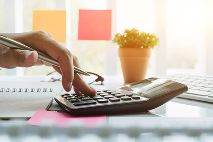 How Much Profit Should You Make on Each Real Estate Deal? Close up view of bookkeeper or financial inspector hands making report, calculating or checking balance. Home finances, investment, economy, saving money or insurance concept