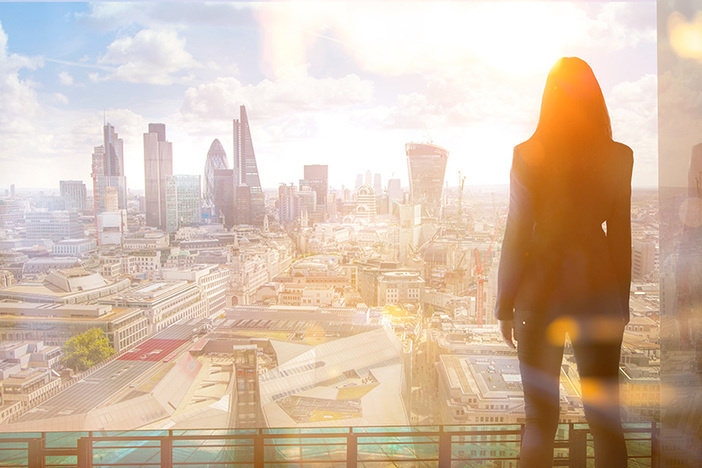 2019’s Top Real Estate Niche for Low-Effort, High-Reward Wealth Building Young woman looking over the City of London at sun set.