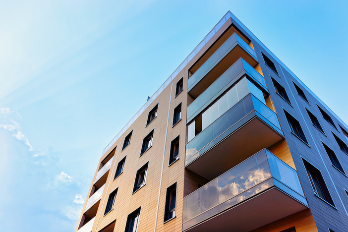 New FHA Guidelines Could Make It Tougher to Get a Loan, Easier to Buy a Condo New modern apartment building exterior concept. Residential house and home.