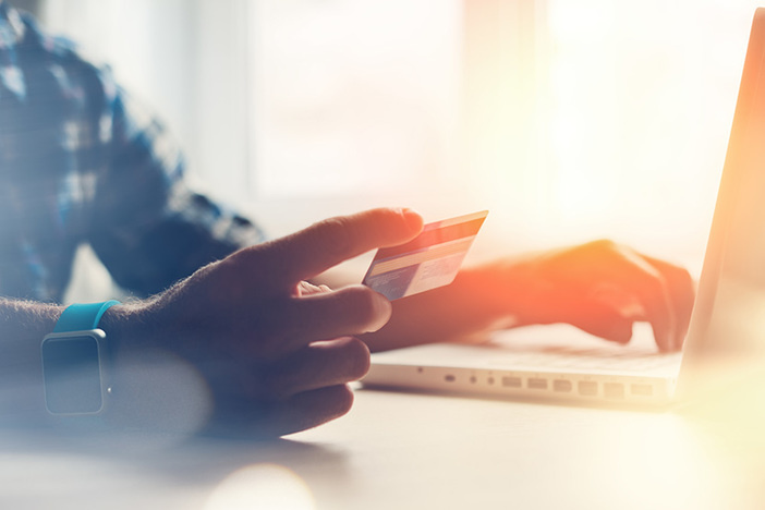 Southwest Airlines Companion Pass Is Now More Difficult to Earn (But Still an Amazing Deal!) Man holding credit card and using laptop. Online payment