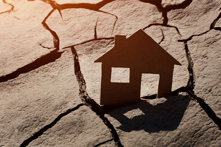 Opinion: Proposed Restrictions on Landlords Could Devastate Investors—and the Housing Industry in General Paper house on cracked earth, crisis concept