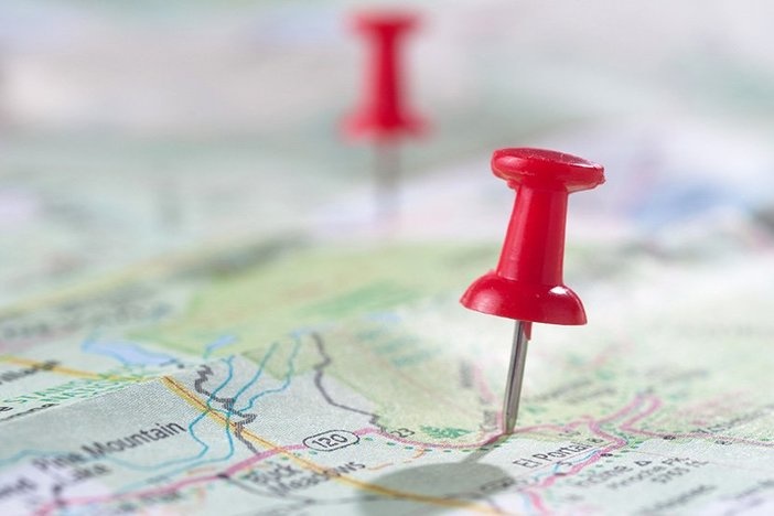 Learn to Invest Remotely by Joining the Dream Investment Adventure Travel concept with red pushpin