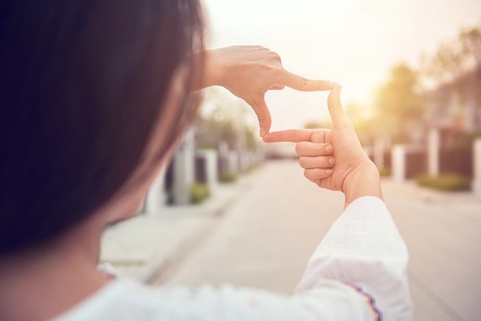 How Much Profit Should You Make on a Rental Property? Close up of woman hands making frame gesture with sunlight outdoors