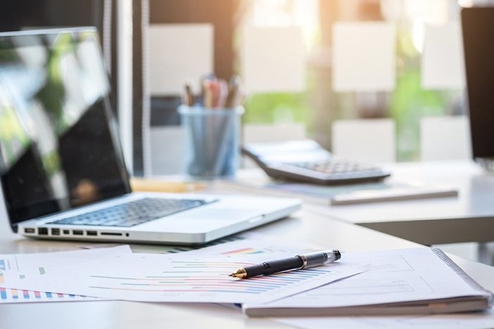 What Landlords Need To Know About Tracking Expenses for Rental Properties Business desk with a keyboard, report graph chart, pen and tablet on white table