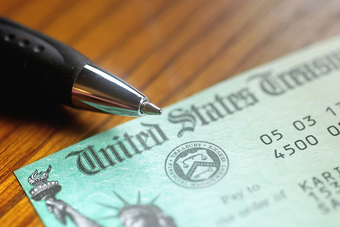 What the December Coronavirus Stimulus Might Mean for Real Estate Investors Paper check from the United States Treasury