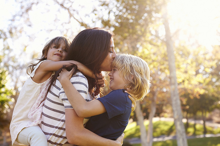 The 5 Best Places to Raise a Family in the U.S. Mother Carrying Son And Daughter As They Play In Park