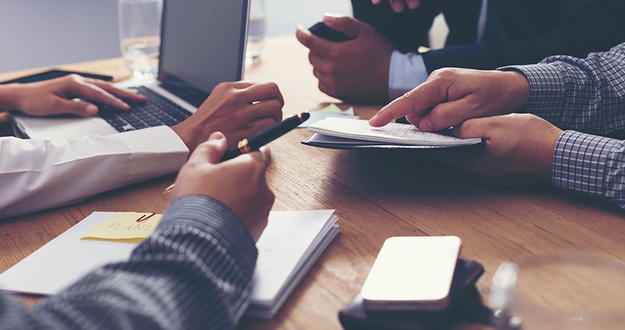 4 Essential Steps to Take BEFORE Seeking Private Money business partners discussing documents and ideas at meeting