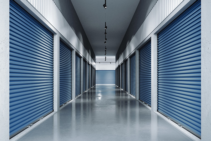 3 Reasons to Switch From Residential to Commercial Real Estate Storage facilities with blue doors. Interior units. 3d rendering