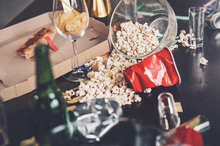 The Landlord’s Itemized List of Common Security Deposit Deductions Close-up view of popcorn, glasses and trash on messy table after party